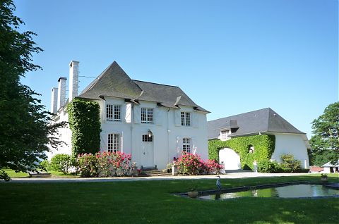 Clos mirabel manor house with fish pond in foreground.