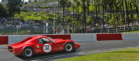 Red car on road driving fast, formula one race.