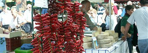 French market stall selling red peppers.