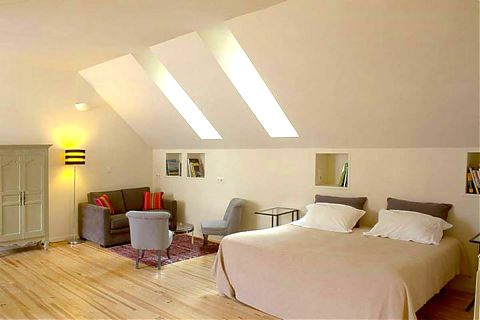 The loft apartment bedroom with double bed and sofa bed.